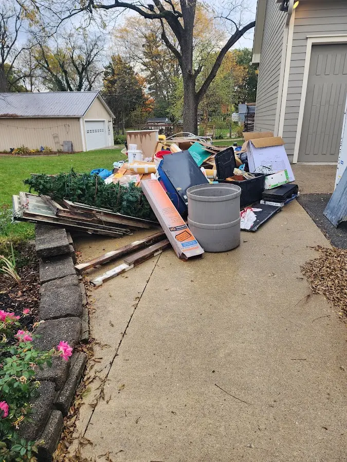 Dumpster being loaded with debris for 10 Yard Dumpster Rental in El Rio